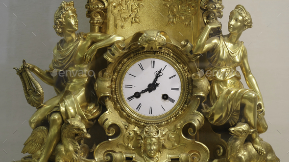 Ancient vintage brass pendulum clock. Vintage gold watch