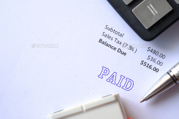 Paid invoice and Rubber Stamp on paper , - Stock Photo - Images
