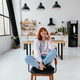 Woman sitting on a chair in a modern kitchen - PhotoDune Item for Sale