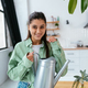 Woman holds a watering can in her hands at home - PhotoDune Item for Sale