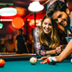 Couple dating, flirting and playing billiard in a pub - PhotoDune Item for Sale