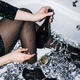 Happy young woman in evening dress sitting in the bathtub drinking champagne and having fun - PhotoDune Item for Sale