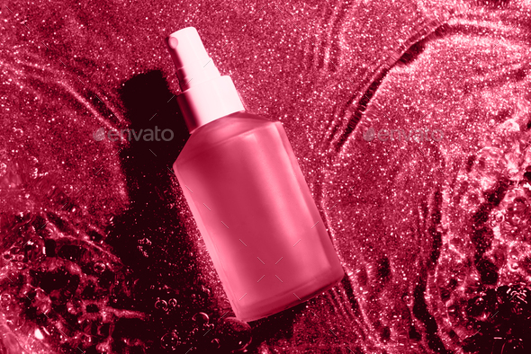Transparent cosmetic bottle in water - Stock Photo - Images