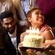 Close Up Of Group Of Friends Around Piano Celebrating Woman&#39;s Birthday With Cake - PhotoDune Item for Sale