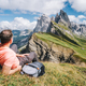 A man with backpack enjoy landscape of Seceda peak in Dolomites Alps, Odle mountain range, South - PhotoDune Item for Sale