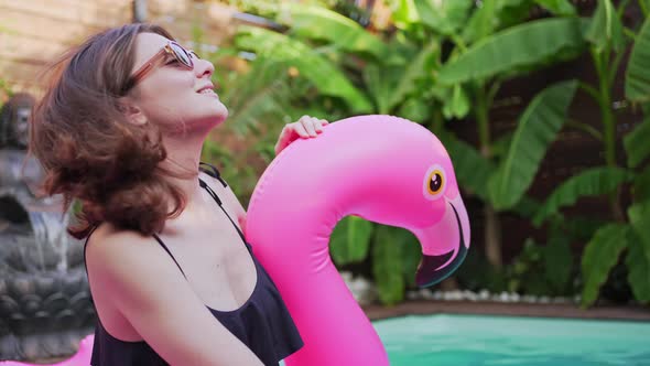 Beautiful Young Woman in the Pool on Flamingo