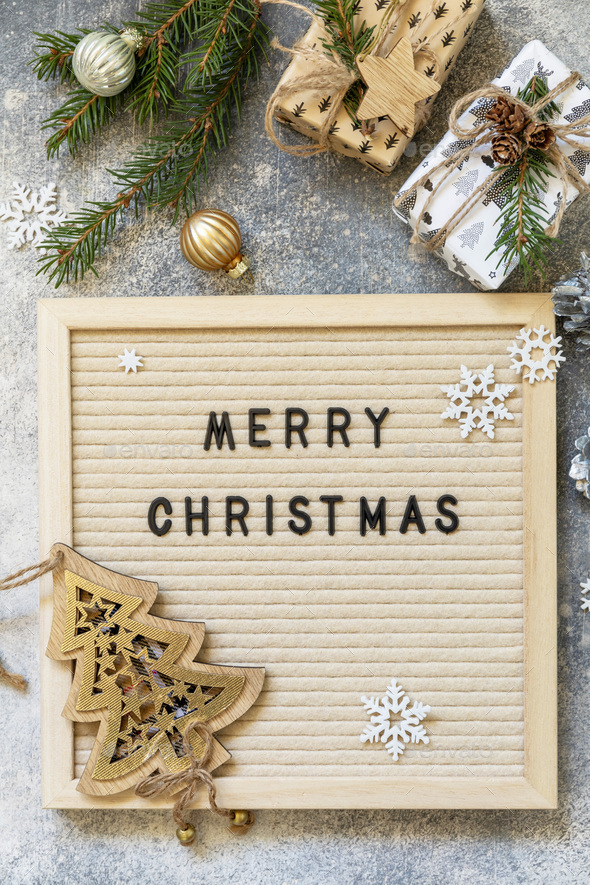 Merry Christmas lettering on letter board, gifts boxs and holidays decorations.