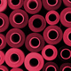 Close up of colored thread coils, thread spools background. Color of the year 2023, viva magenta. - PhotoDune Item for Sale
