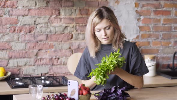 Cheerful Blondie Holds Fresh Mint Leaves