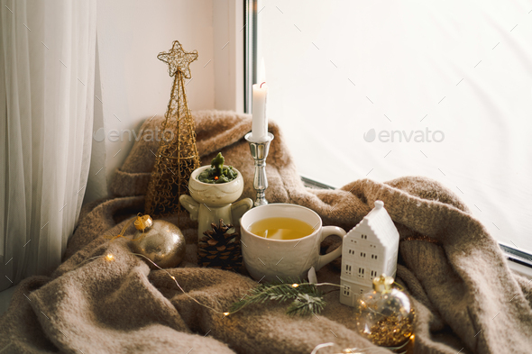 Hot tea, candles, Christmas golden balls and decorations. Christmas holiday mood. - Stock Photo - Images