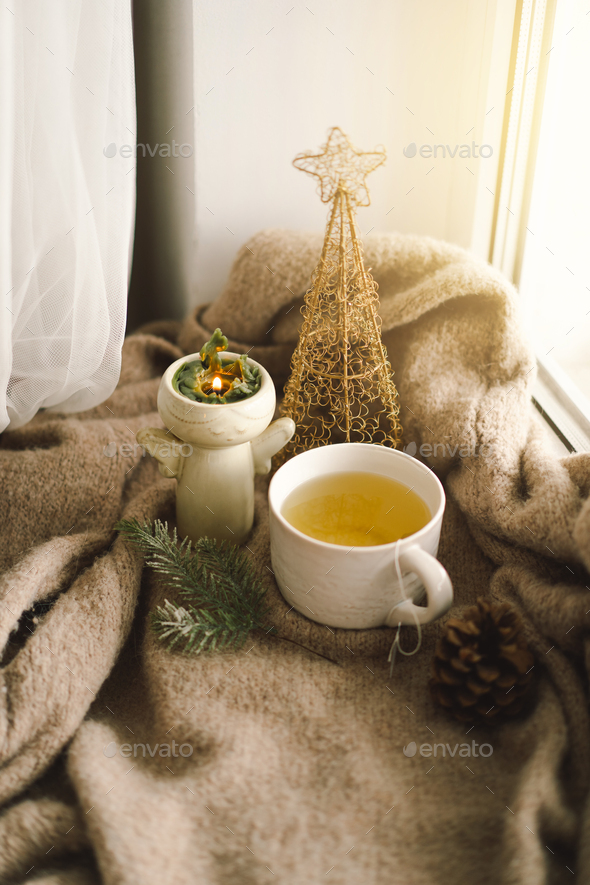 Hot tea, candles, Christmas golden balls and decorations. Christmas holiday mood - Stock Photo - Images