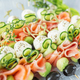 Appetizers with red fish, avocado, mozzarella and cucumbers close-up. Food and catering concept. - PhotoDune Item for Sale