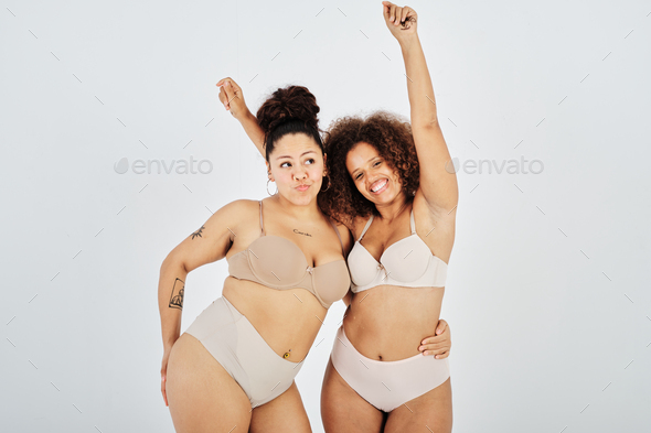 Delighted curvy Hispanic ladies in underwear against gray background Stock  Photo by alvarogonzalez