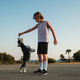 Boy spending time with dog on road in countryside - PhotoDune Item for Sale
