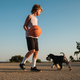 Boy holding basketball on asphalt near Miniature Schnauzer - PhotoDune Item for Sale