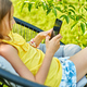 Happy kid girl playing game on mobile phone in the park outdoor - PhotoDune Item for Sale