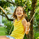 Happy barefoot laughing child girl swinging on a swing in sunset summer day - PhotoDune Item for Sale
