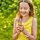 Happy girl with braces eating italian ice cream cone smiling while resting in park on summer day - PhotoDune Item for Sale