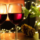 Christmas celebration. Red wine glasses, Xmas presents and decoration on table - PhotoDune Item for Sale