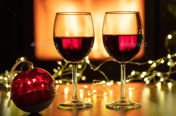 Christmas celebration. Red wine glasses and decoration on table