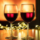 Christmas celebration. Red wine glasses and decoration on table, fireplace background. - PhotoDune Item for Sale