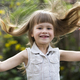 Portrait of a pretty little long-haired blond preschool girl in sleeveless white dress smiling - PhotoDune Item for Sale