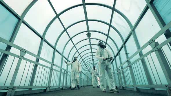 People Use Sprayers To Disinfect Walkway. alt