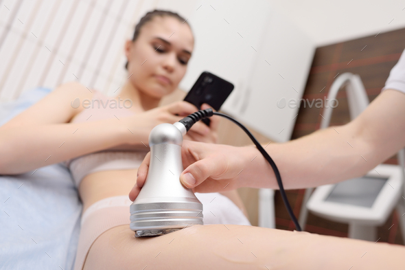 masseur performs cavitation to a young woman - Stock Photo - Images