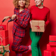 Vertical shot of happy pleased dreamy women pose with wrapped gift boxes prepare for Christmas - PhotoDune Item for Sale
