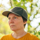 Portrait of female farm worker wearing orange t-shirt and trucker&#39;s hat in walnut tree orchard - PhotoDune Item for Sale