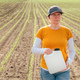 Corn crop protection concept, female farmer agronomist holding jerry can container canister - PhotoDune Item for Sale