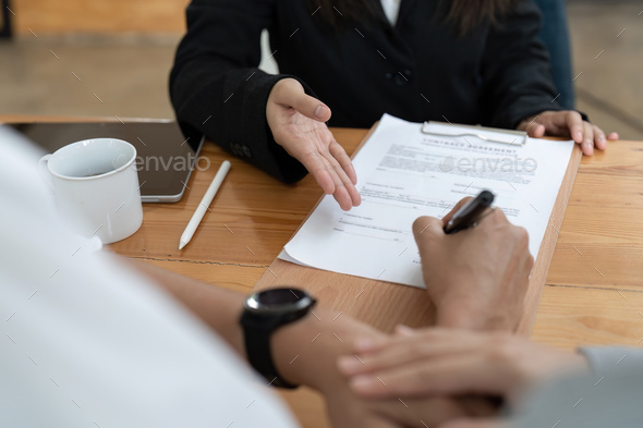 Young couple signing contract agreement with real estate agent. - Stock Photo - Images