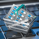Shopping basket with pills and syrringe  on  laptop keyboard..  Buying  pharma and medicines online. - PhotoDune Item for Sale