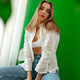 Portrait of attractive lovely girl wearing crop top and shirt posing over green studio background - PhotoDune Item for Sale