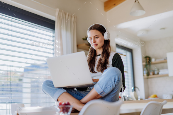 Young woman having homeoffice in her apartment. - Stock Photo - Images