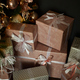 Pink Christmas gifts under fir tree on floor in room - PhotoDune Item for Sale