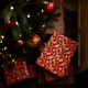 Red Christmas gifts under fir tree on floor in room - PhotoDune Item for Sale