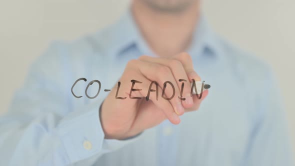 Co-Leading, Man Writing on Transparent Screen alt