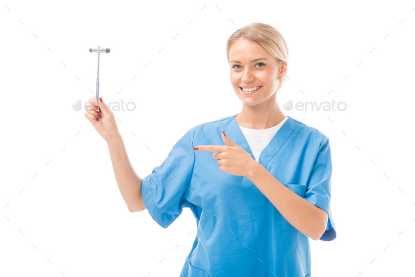 smiling young neurologist pointing at reflex hammer isolated on white