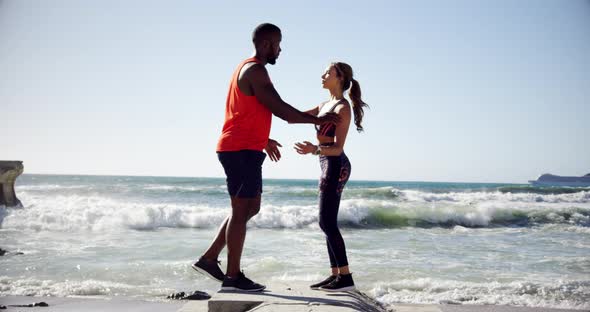 Couple exercising on the beach 4k