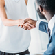 cropped image of multicultural businesspeople shaking hands in office - PhotoDune Item for Sale