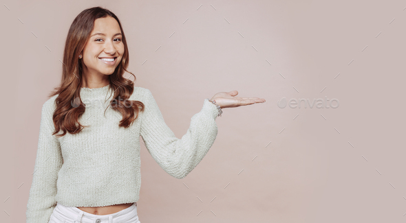 Young attractive woman shows commercial offer with hands