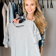 young smiling woman fitting grey tshirt at home - PhotoDune Item for Sale