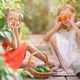 Adorable girls having fun in greenhouse. Portrait of kid with basket with vegetables - PhotoDune Item for Sale