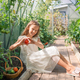 Adorable girl harvesting vegetables in greenhouse. Portrait of kid with basket full of vegetables - PhotoDune Item for Sale
