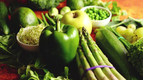 Fresh Green Vegetables and Fruits Assortment Placed on a Rusty Metal alt