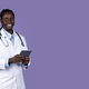 Friendly african american doctor holding digital tablet, copy space - PhotoDune Item for Sale
