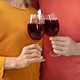 Cropped of loving couple holding glasses with red wine - PhotoDune Item for Sale
