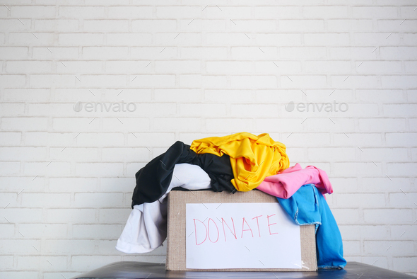 Donation box with donation clothes on table with copy space