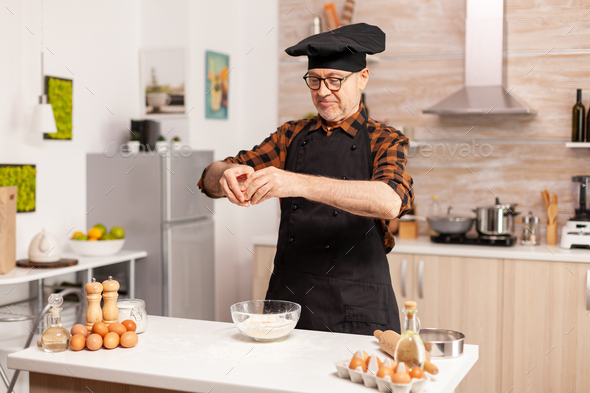 Elderly man cracking eggs Stock Photo by DC_Studio | PhotoDune